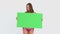 Woman dancing in a bikini while holding a blank poster