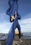 Woman dancing with blue fabric on the beach in Connecticut.