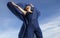 Woman dancing with blue fabric on the beach in Connecticut.