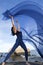 Woman dancing with blue fabric on the beach in Connecticut.