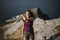 Woman dancing at the coastline on the top of a cliff,