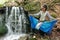 woman dancing near a waterfall