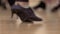 Woman in dancing shoes makes the movement of the floor