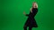 Woman dancing and singing in black dress. Green screen