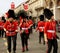 Woman dancing on the street in the uniform of British Royal guards