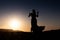 Woman dancing to the famous Arab belly dance. With sunset in the arid desert plain of Namibe. Africa. Angola