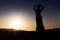 Woman dancing to the famous Arab belly dance. With sunset in the arid desert plain of Namibe. Africa. Angola