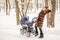 Woman dancing while winter walk with a stroller.