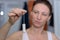 Woman dangling a clean tampon from her fingers