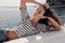 Woman with dark hair in casual clothes relaxing on yacht in open