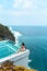 Woman with dark hair relaxing in transparent swimming pool with fantastic ocean view
