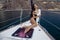 Woman with dark hair in swimming suit relaxing on yacht in open