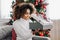 Woman with dark skin and kinky hair opening present box
