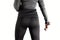 Woman in dark sport leggings, lifts dumbbell standing