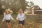 A woman with a daughter as a teenager running, holding hands outdoors