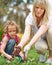 Woman with daughter gardening