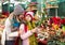 Woman with daughter looking at floral decoration at Cristmas fair