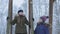 Woman and daughter relaxing on wooden swings in snowy day