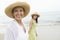 Woman And Daughter Walking At Beach