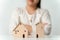 Woman is deciding to choose house with Small Wooden House Model with Question Marks, Planning to buy property. Choose what`s the