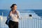 Woman on deck of ferry, female standing in strong wind, enjoying sea travel