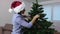 Woman decorate artificial Christmas tree
