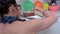 Woman decorate cake with candles on the table in kitchen