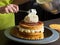 Woman decorating a cake with icing cream