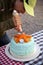 Woman Decorating Cake Outdoors