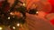 Woman decorating christmas tree with ball