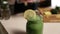 Woman decorating jar of healthy green smoothie