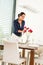 Woman decorating red roses dining room wife