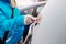 Woman deicing rear car windshield