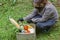 Woman delivering donations box with food during Covid 19 outbreak.Feme volunteer collects food in a box standing on the grass