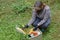 Woman delivering donations box with food during Covid 19 outbreak.Feme volunteer collects food in a box standing on the grass