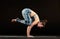 Woman demonstrating a crow pose in yoga