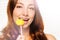 Woman with dental braces biting off swirl lollipop