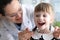 Woman dentist examines teeth in clinic at child