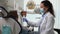 Woman dentist showing teeth in mirror to patient