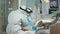 Woman at dentist while treatment process in coronavirus pandemic