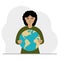 A woman deposits the planet Earth in his hand. Earth day holiday concept, saving the planet, global warming or climate