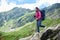 Woman descends the rocky terrain. Fagaras Mountains, Romania