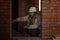 A woman designer-architect in a white construction helmet takes measurements of the brick walls of a house. Repair and interior