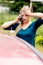 Woman dialing her phone after car crash