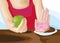 Woman on dieting for good health concept. Close up female using hand push out her favorite donuts and choose green apple and