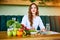 Woman dietitian in medical uniform with tape measure working on a diet plan sitting with different healthy food ingredients in the