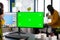 Woman digital artist working editing creative photo using greenscreen, chroma key isolated display