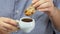 Woman dips cantucci cookies in espresso coffee