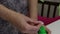 A woman dips cotton wool in alcohol and treats her hands before giving an injection