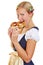 Woman in dirndl biting in a pretzel